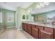 Bathroom featuring double vanity, a separate shower and many large mirrors and a window at 4094 Windcrest Dr, Wesley Chapel, FL 33544