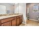 Well-lit bathroom featuring a double sink vanity with a granite countertop and a separate shower area at 4094 Windcrest Dr, Wesley Chapel, FL 33544