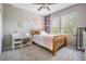 Bright bedroom with a wooden bed frame, large windows, and a cozy writing desk at 4094 Windcrest Dr, Wesley Chapel, FL 33544