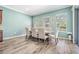 Bright dining area with wood floors and views to the backyard at 4094 Windcrest Dr, Wesley Chapel, FL 33544
