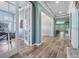 Elegant foyer with wood-look tile flooring, open archways, and views into the office and dining area at 4094 Windcrest Dr, Wesley Chapel, FL 33544
