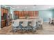 Kitchen with stainless steel appliances, granite countertops, a large island with seating, and light-blue walls at 4094 Windcrest Dr, Wesley Chapel, FL 33544