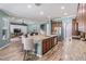 Spacious kitchen flows into the living area with wood-look floors and a large island at 4094 Windcrest Dr, Wesley Chapel, FL 33544