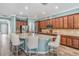 Open kitchen boasts a large island, stainless appliances, and wood-look flooring at 4094 Windcrest Dr, Wesley Chapel, FL 33544