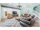 Comfortable living area featuring wood-look floors, ceiling fan, and cozy seating at 4094 Windcrest Dr, Wesley Chapel, FL 33544