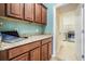 Mud room with cabinets, granite countertop, and laundry room access featuring a workspace on the counter at 4094 Windcrest Dr, Wesley Chapel, FL 33544