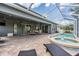 An expansive screened-in patio with a pool, spa, and ample space for outdoor seating at 4094 Windcrest Dr, Wesley Chapel, FL 33544