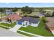 An aerial view of a modern home showcasing its well-manicured lawn and neighborhood setting at 4260 Baudelaire Ct, Brooksville, FL 34604