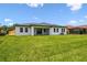 This home has a manicured backyard and a covered patio at 4260 Baudelaire Ct, Brooksville, FL 34604