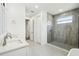 Modern bathroom with double sinks, glass shower, and neutral tile flooring at 4260 Baudelaire Ct, Brooksville, FL 34604