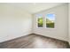 This bedroom is a blank canvas with wood floors and bright windows at 4260 Baudelaire Ct, Brooksville, FL 34604