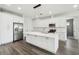 Modern kitchen with white cabinets, stainless steel appliances, and a large marble island at 4260 Baudelaire Ct, Brooksville, FL 34604