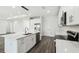 Bright kitchen with white cabinets, an island, and modern stainless steel appliances at 4260 Baudelaire Ct, Brooksville, FL 34604