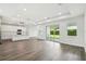 Bright, airy living space with modern flooring and sliding glass doors leading to the outdoors at 4260 Baudelaire Ct, Brooksville, FL 34604