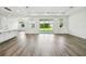 Open-concept living space with luxury vinyl floors and sliding glass doors to the backyard at 4260 Baudelaire Ct, Brooksville, FL 34604