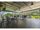 Inviting outdoor screened-in seating area with stylish tables and chairs, perfect for relaxing and enjoying beautiful views at 4260 Baudelaire Ct, Brooksville, FL 34604