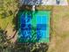 Aerial view of vibrant blue and green pickleball courts, offering a fun and active recreational option for residents at 4260 Baudelaire Ct, Brooksville, FL 34604
