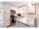 Well-lit kitchen with white cabinets, stainless steel appliances, and a functional layout for cooking at 4545 Annette St, New Port Richey, FL 34652