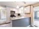 Stylish kitchen featuring white cabinets, modern appliances, and a breakfast bar with pendant lighting at 4545 Annette St, New Port Richey, FL 34652