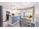 Bright kitchen with stainless steel appliances, white cabinetry, and a cozy breakfast bar at 4545 Annette St, New Port Richey, FL 34652