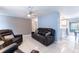Bright living room features modern tile floors, cozy seating, and a pass-through to the kitchen at 4545 Annette St, New Port Richey, FL 34652