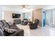 Inviting living room with tile floors, plush seating, and a large TV for comfortable relaxation at 4545 Annette St, New Port Richey, FL 34652