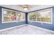 Bright sunroom with large windows and ceiling fan at 4545 Annette St, New Port Richey, FL 34652