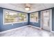 Bright sunroom with large windows and ceiling fan at 4545 Annette St, New Port Richey, FL 34652