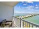 Cozy balcony seating and expansive water and bridge views under a bright sky at 500 Treasure Island Cswy # 607, Treasure Island, FL 33706