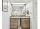 Bathroom vanity with double sinks, granite counters, and a large mirror in a neutrally decorated space at 500 Treasure Island Cswy # 607, Treasure Island, FL 33706