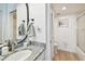 This is a clean bathroom with hard floors and granite vanity at 500 Treasure Island Cswy # 607, Treasure Island, FL 33706