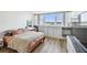 Bedroom with a large window offering city views, a television, and lots of storage space at 500 Treasure Island Cswy # 607, Treasure Island, FL 33706