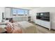Bedroom with large windows offering stunning city views, built in shelves, and modern furnishings at 500 Treasure Island Cswy # 607, Treasure Island, FL 33706