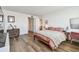 Comfortable bedroom features hardwood floors, desk, closet and artwork at 500 Treasure Island Cswy # 607, Treasure Island, FL 33706
