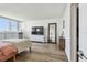 Bright bedroom featuring sleek hardwood flooring, television, and built in storage and display space at 500 Treasure Island Cswy # 607, Treasure Island, FL 33706