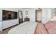 Comfortable bedroom featuring TV, large closet, hardwood floors, and view to bathroom at 500 Treasure Island Cswy # 607, Treasure Island, FL 33706