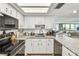 Bright kitchen features white cabinets, granite countertops, and stainless-steel appliances at 500 Treasure Island Cswy # 607, Treasure Island, FL 33706