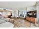 Bright living room features hard flooring, a modern sofa, and a view into the bedroom at 500 Treasure Island Cswy # 607, Treasure Island, FL 33706