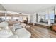 Bright living room features hard flooring, a modern sofa, and a view into the bedroom at 500 Treasure Island Cswy # 607, Treasure Island, FL 33706