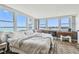 Bright bedroom features hardwood floors, water views, a desk and chair, and natural light at 500 Treasure Island Cswy # 607, Treasure Island, FL 33706