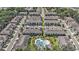 Aerial shot of a neighborhood with multiple townhomes, streets, parking spaces and community pool at 5005 Blue Latan Ln, Tampa, FL 33610