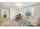 Bright bedroom with neutral carpet, large window, and a cozy chaise lounge at 5005 Blue Latan Ln, Tampa, FL 33610