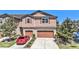 Charming two-story townhome with a double car garage and beautifully landscaped front yard at 5005 Blue Latan Ln, Tampa, FL 33610