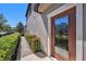 Inviting front door featuring a decorative glass door and well-maintained landscaping at 5005 Blue Latan Ln, Tampa, FL 33610
