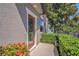 Inviting front porch featuring a decorative glass door and well-maintained landscaping at 5005 Blue Latan Ln, Tampa, FL 33610