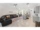 Open-concept living space featuring a modern kitchen, dining area, and comfortable living room at 5005 Blue Latan Ln, Tampa, FL 33610