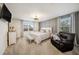 Comfortable primary bedroom boasts a neutral palette, modern decor, and bright natural light at 5005 Blue Latan Ln, Tampa, FL 33610