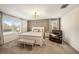 Inviting primary bedroom with soothing colors, accent wall, and large windows at 5005 Blue Latan Ln, Tampa, FL 33610