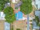 Overhead view of a backyard with a private pool and mature trees, offering a serene and secluded outdoor space at 504 E Lee St, Plant City, FL 33563