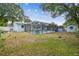 Spacious backyard featuring a fenced-in pool area, shed, and well-maintained lawn, ideal for outdoor living at 504 E Lee St, Plant City, FL 33563